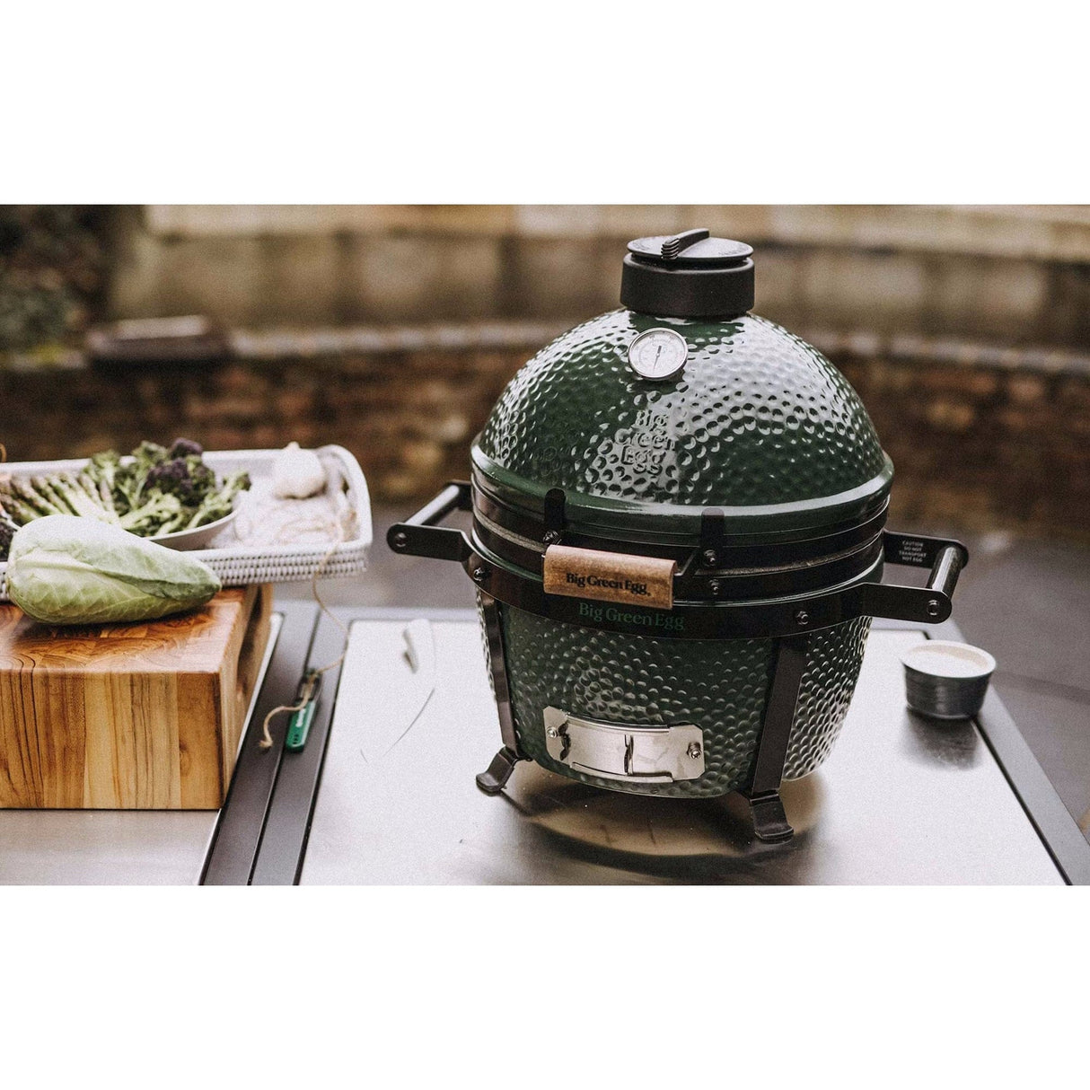 Big Green Egg MiniMax Bundle on table next to veggies