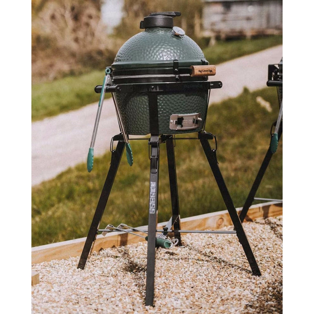 Big Green Egg MiniMax Bundle on gravel next to road