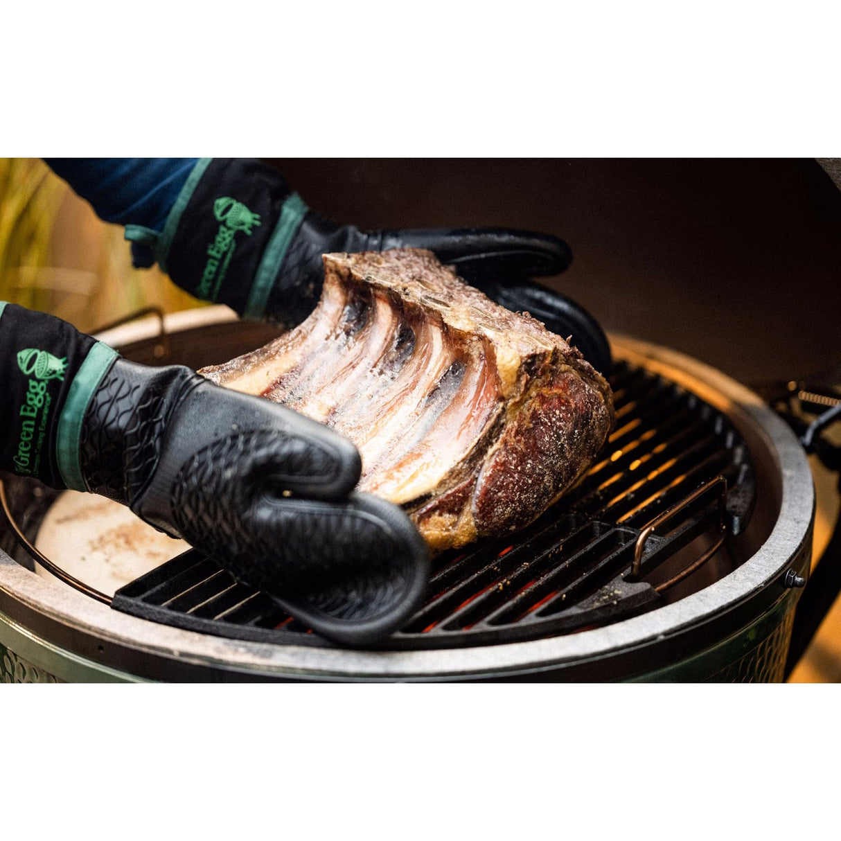 XL EGG Mahogany Table Bundle man with gloves grilling ribs