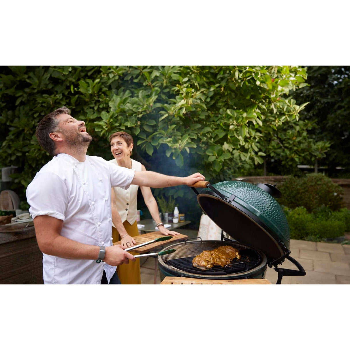 XL EGG IntEGGrated Nest Bundle family laughing while grilling