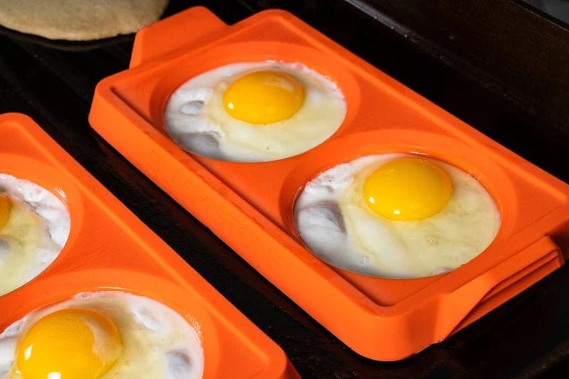 sunny side up eggs cooked using Blackstone - 2 Section Egg Ring Tray