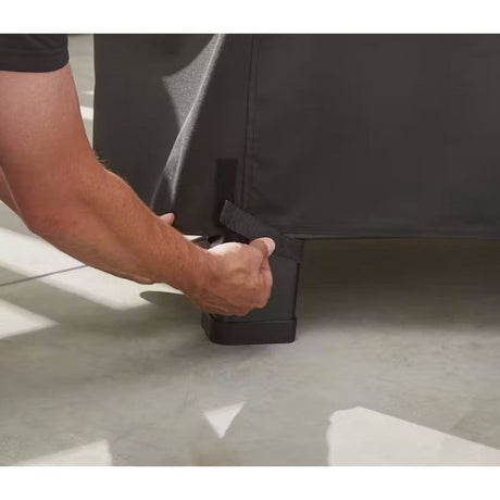 Searwood XL 600 Premium Grill Cover man tightening the grill cover