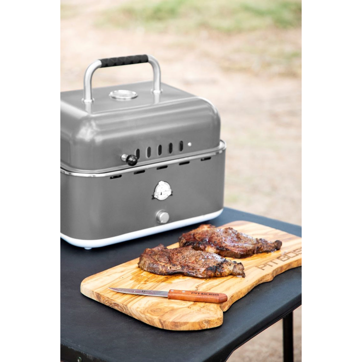 Pit Boss Grills Portable Charcoal Grill steak on cutting board