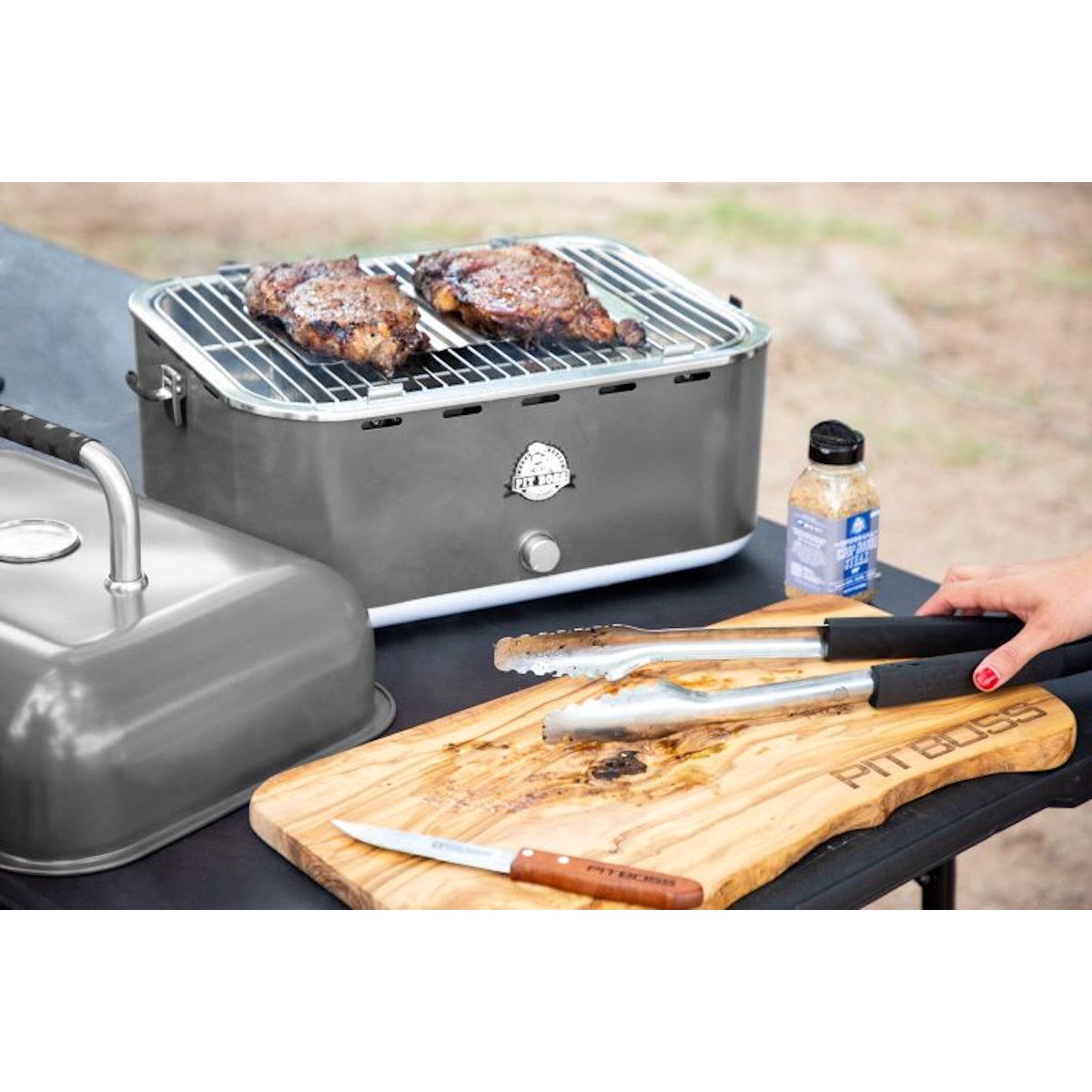 Pit Boss Grills Portable Charcoal Grill grilling on desk