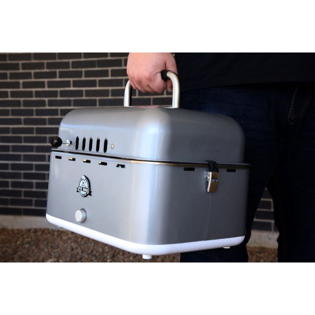 Pit Boss Grills Portable Charcoal Grill man carrying portable grill