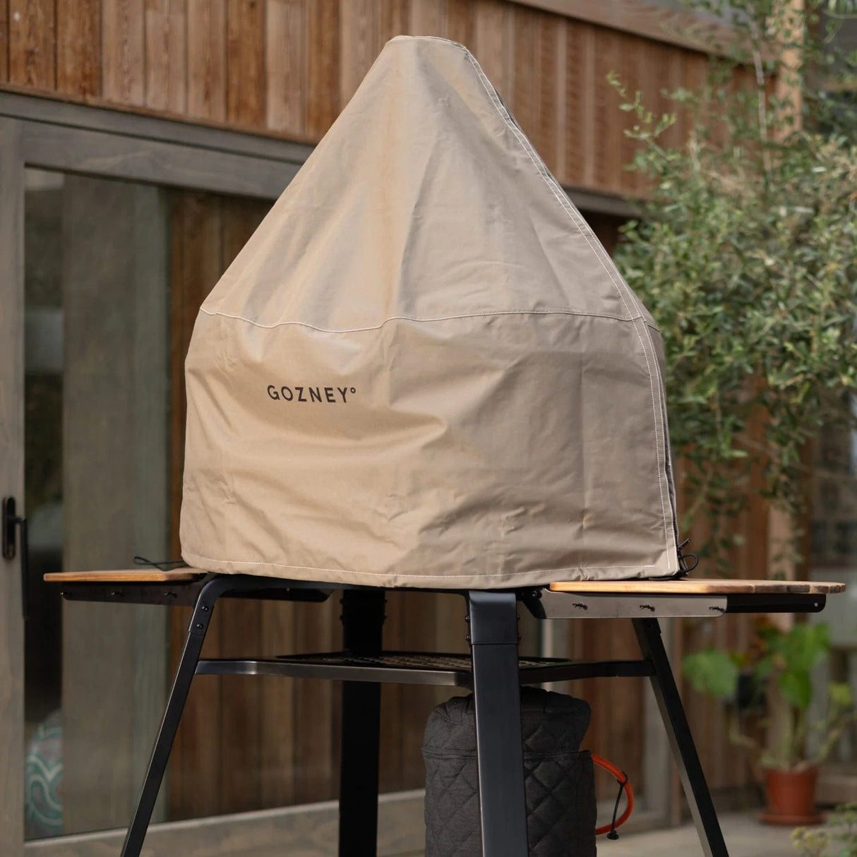 Dome Gen 2 Premium Outdoor Oven Cover being used in backyard