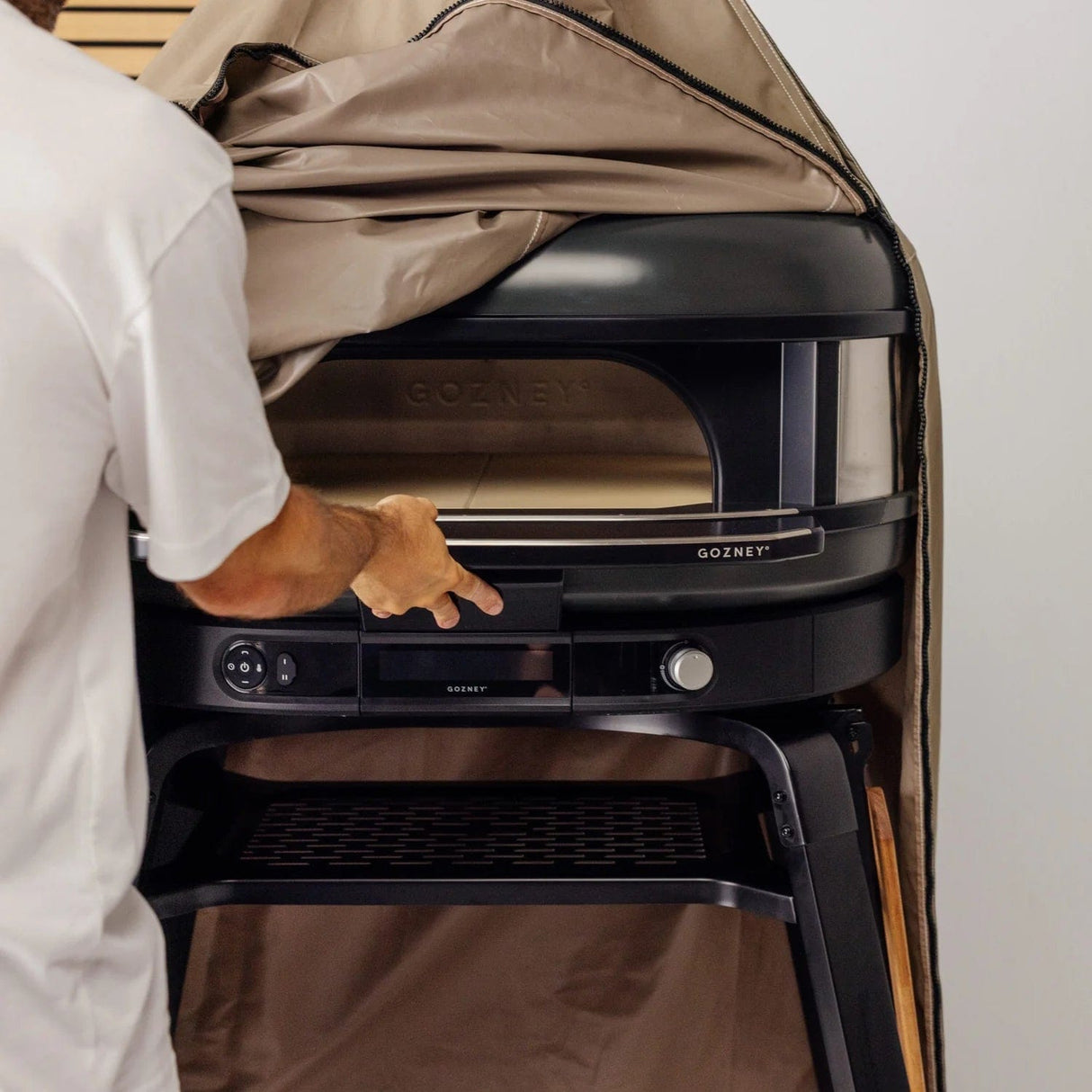 Dome Gen 2 Outdoor Stand Cover man holding oven handle