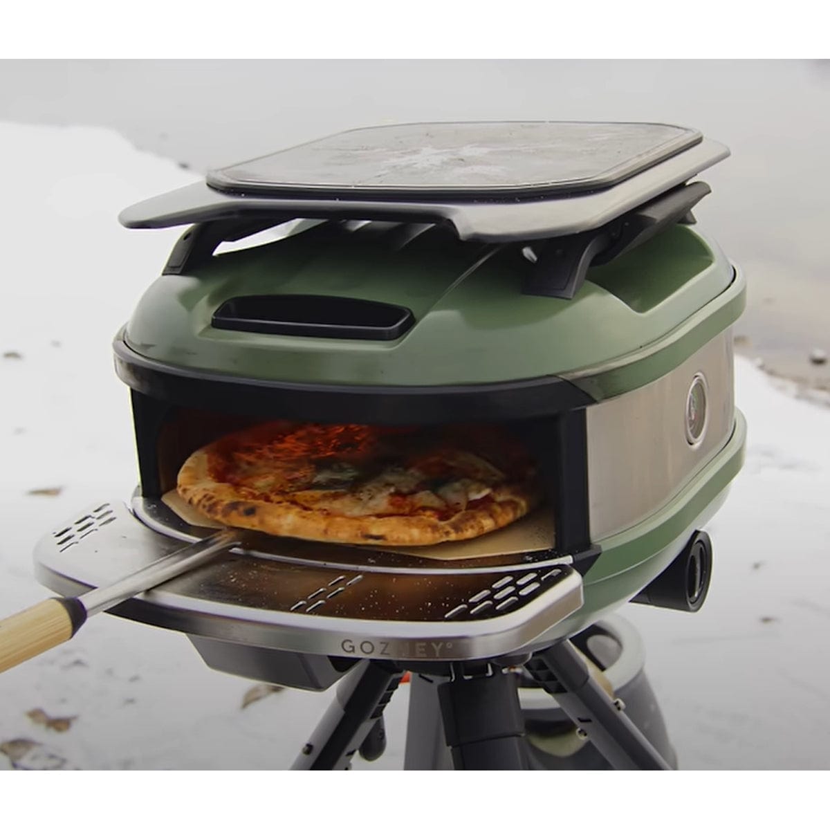 holding pizza with Venture Turning Peel in pizza oven