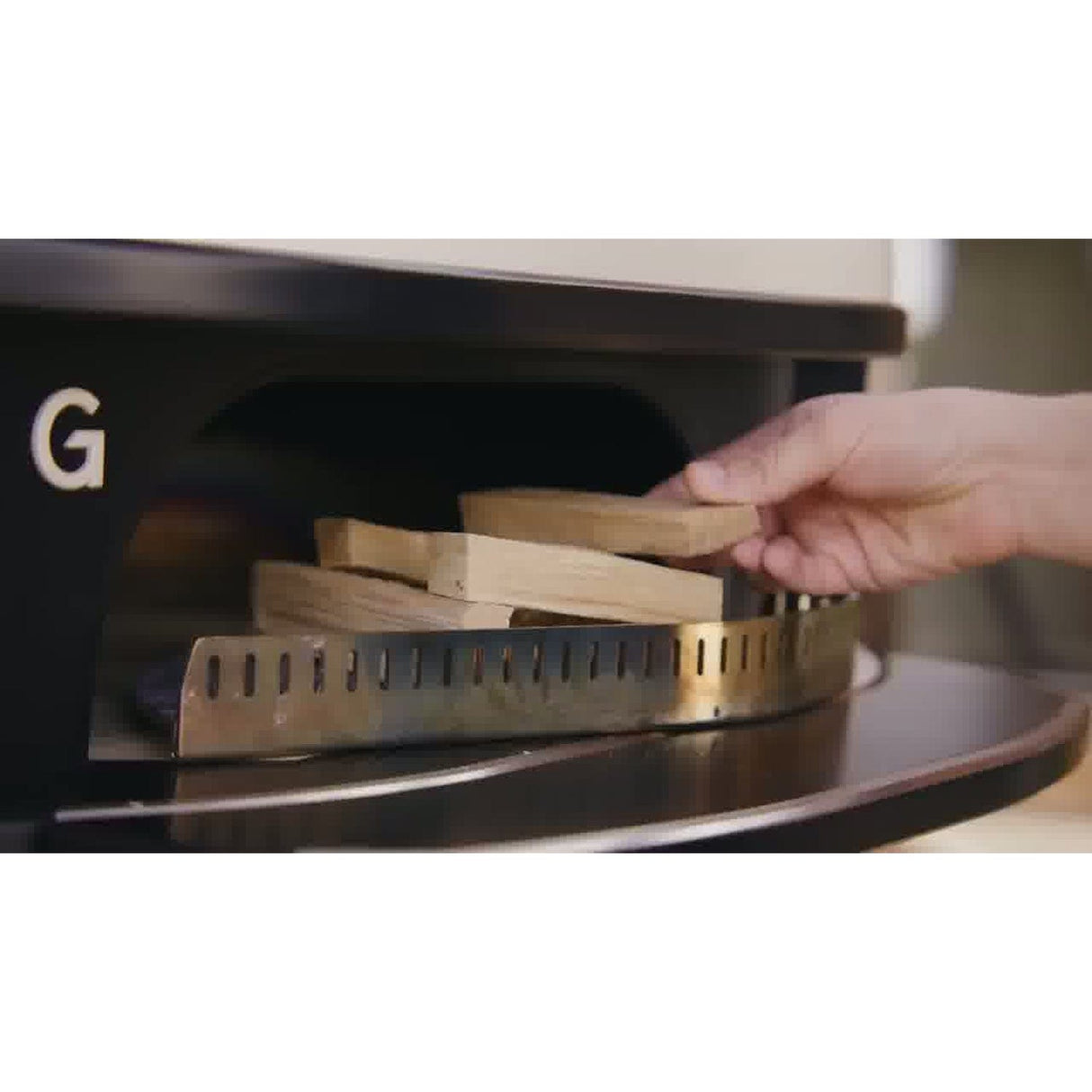 Wood-Fire Control Kit hand stacking wood in oven