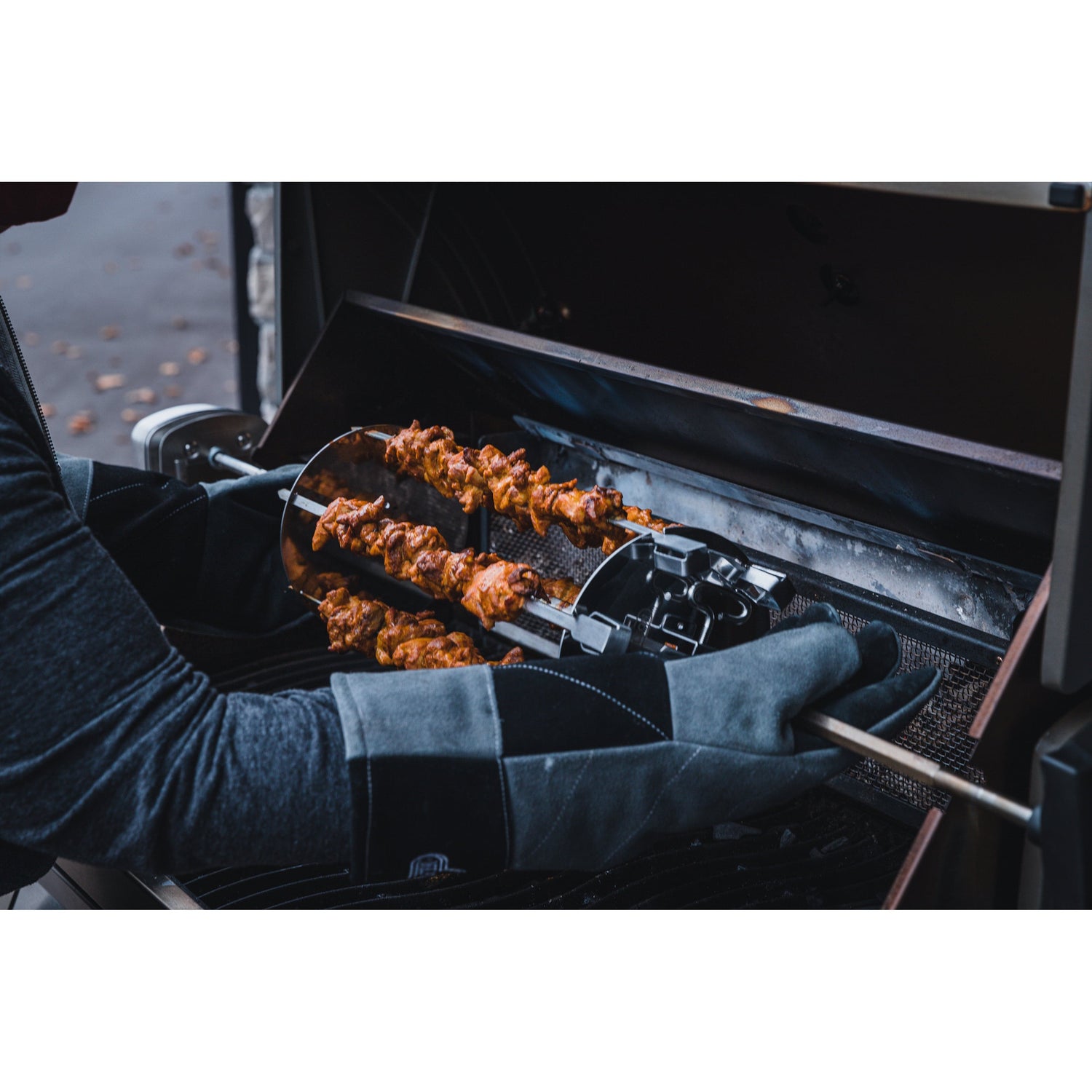 Rotisserie Shish-Kebab Skewer Set man with gloves handling skewer