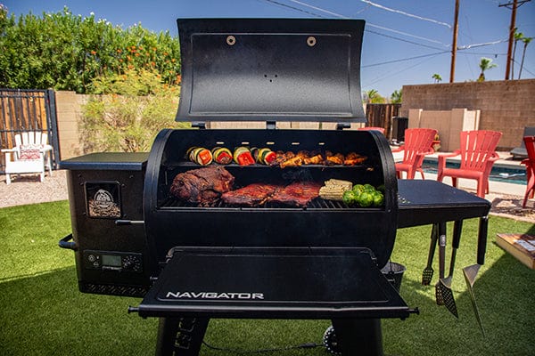 preparing food on Pit Boss 850G Navigator Series Grill in backyard