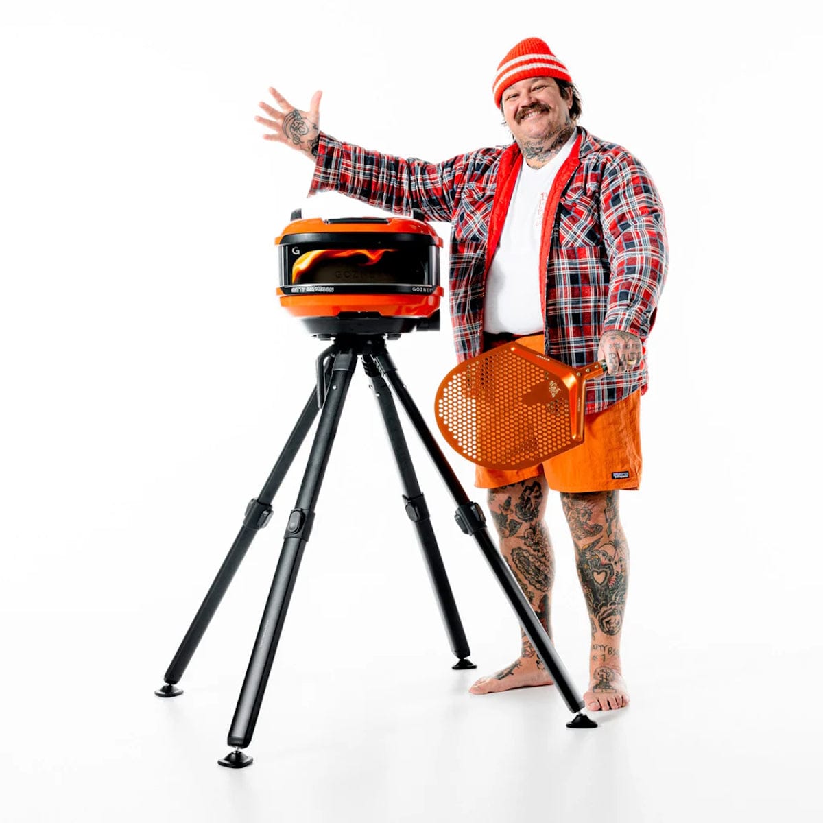 Gozney x Matty Matheson Portable Pizza Oven matty next to flaming oven