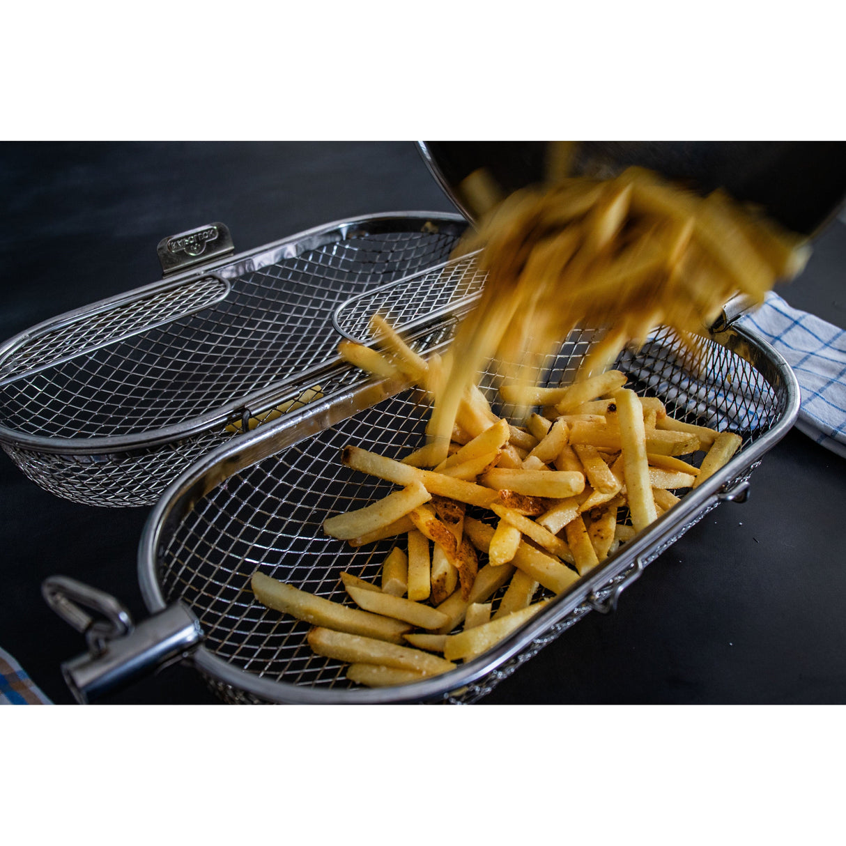 Napoleon Rotisserie Grill Basket pouring fries