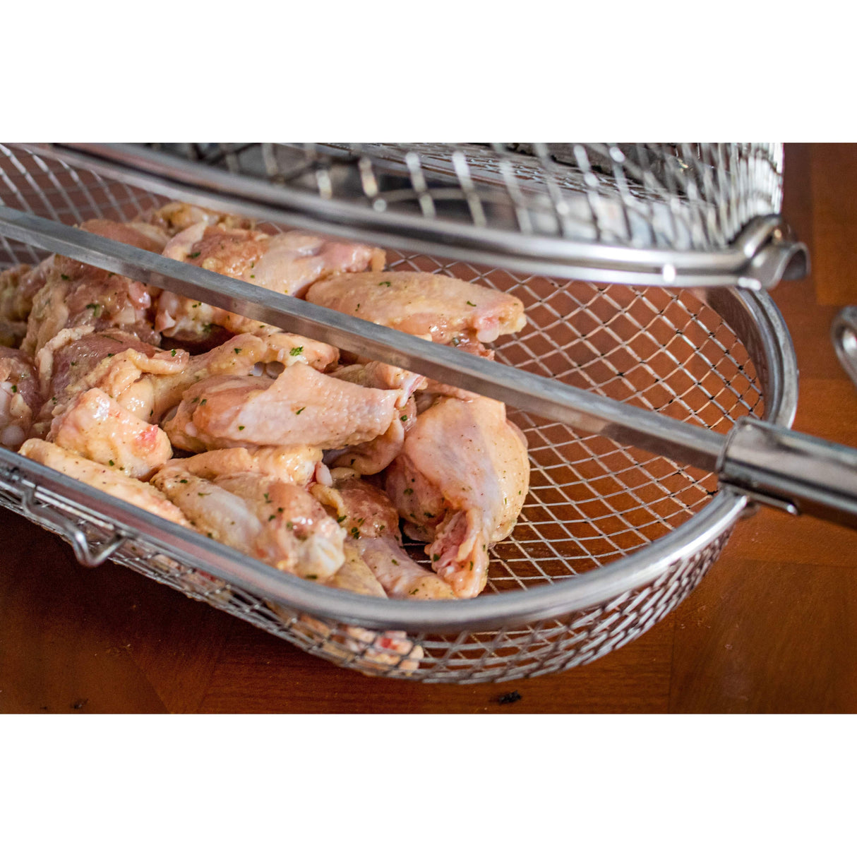 Napoleon Rotisserie Grill Basket seasoned wings in basket