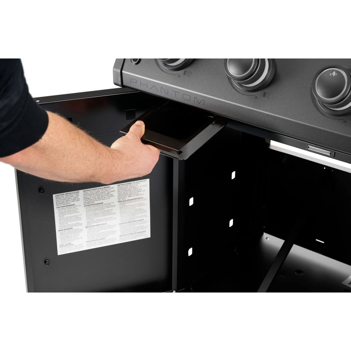 Napoleon Rogue PRO Phantom 30 Grill man opening grill bottom storage