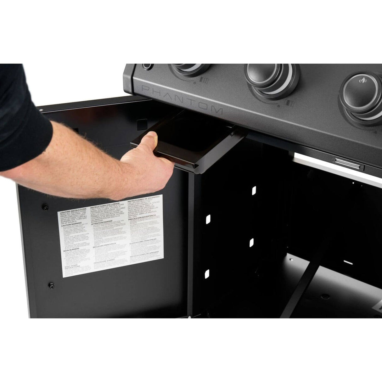 Napoleon Rogue PRO Phantom 30 Grill man opening grill bottom storage