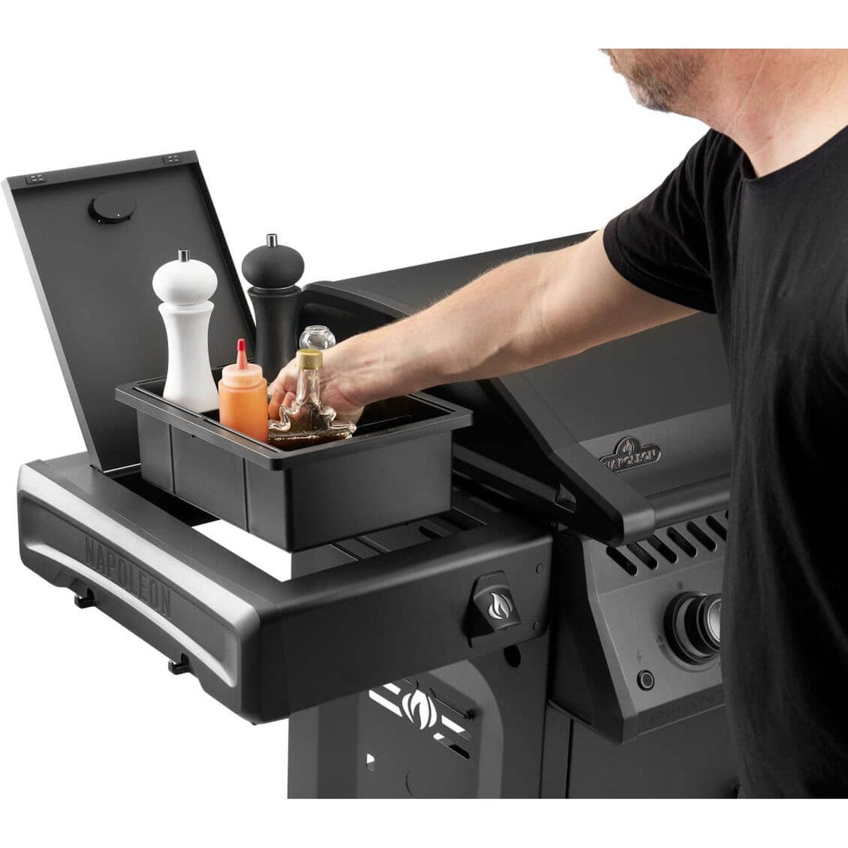 Napoleon Rogue PRO Phantom 30 Grill man handling box of spices in grill shelf