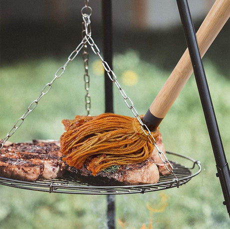 using Barbecue Basting Mop on a meat