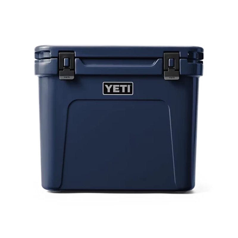 front side of a closed Navy YETI Roadie - 60 Wheeled Cool Box shown with retracted handle