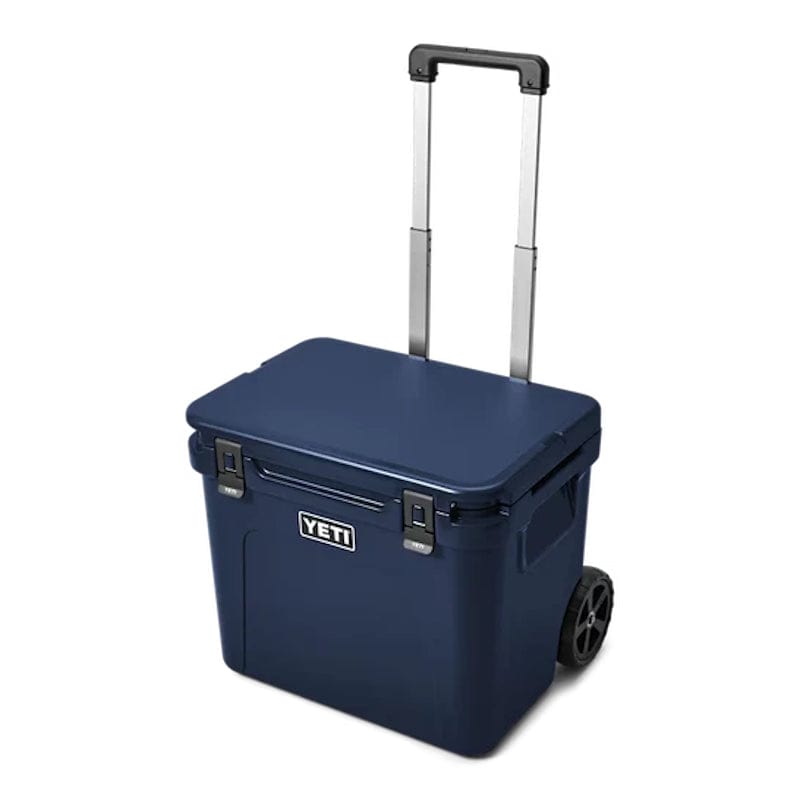 a Navy YETI Roadie - 60 Wheeled Cool Box shown with a periscopic handle
