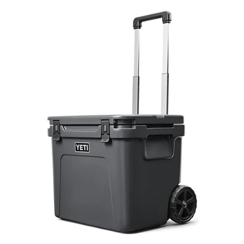 a closed lid Charcoal YETI Roadie - 60 Wheeled Cool Box shown with periscopic handle