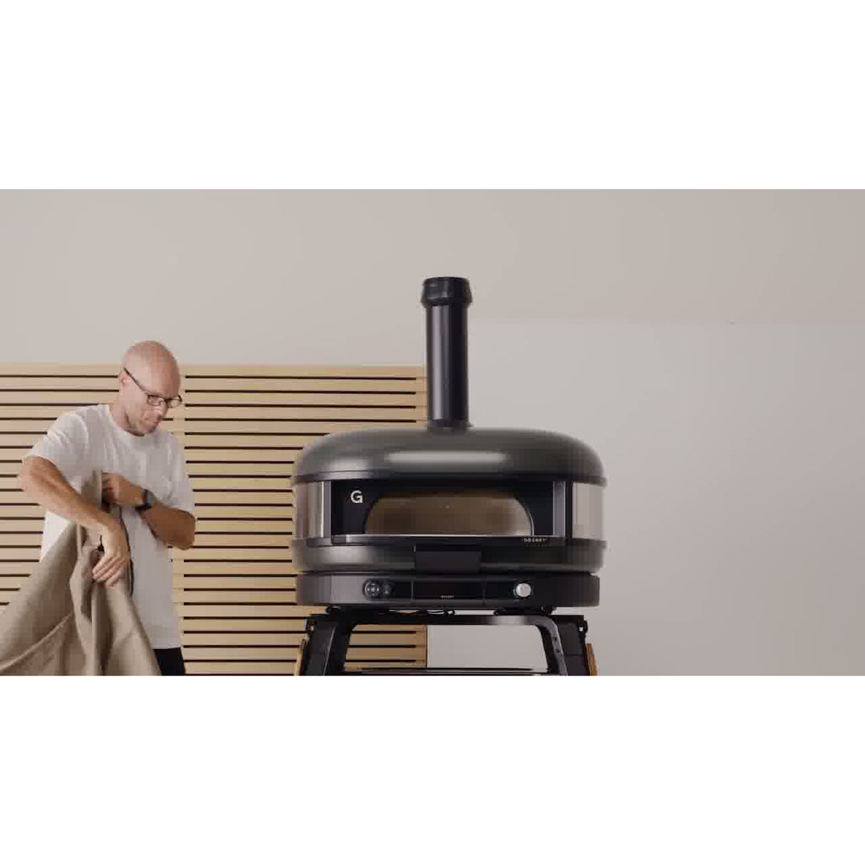 Dome Gen 2 Outdoor Stand Cover man putting on cover