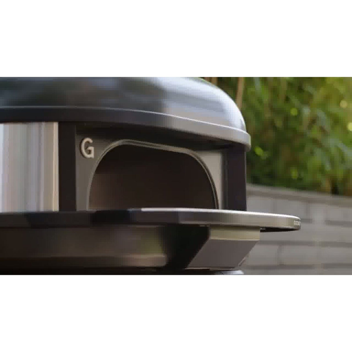 Dome Gen 2 Series Door black oven in backyard