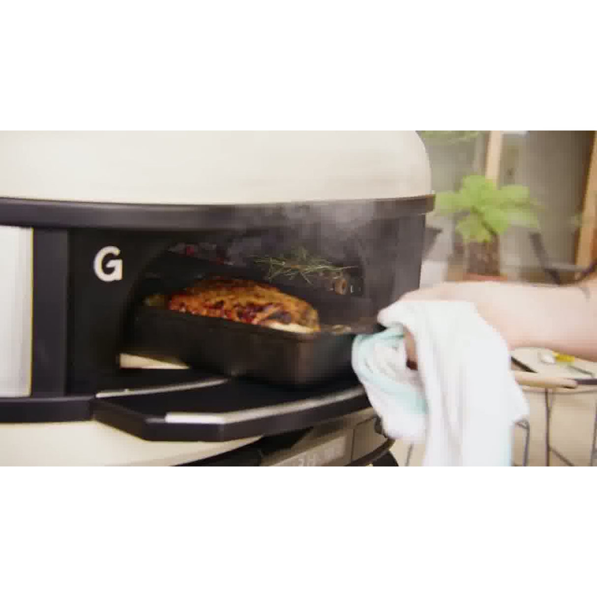Dome Gen 2 Mantel man pulling out tray with meat out of oven