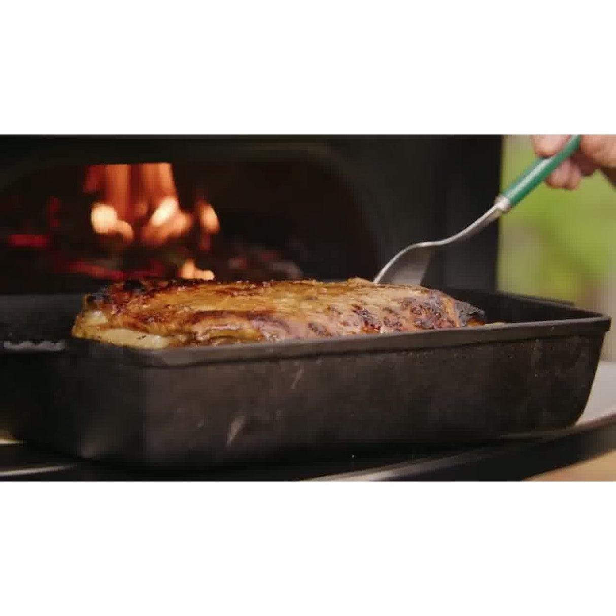 Dome Gen 2 Mantel man cooking meat in tray in oven