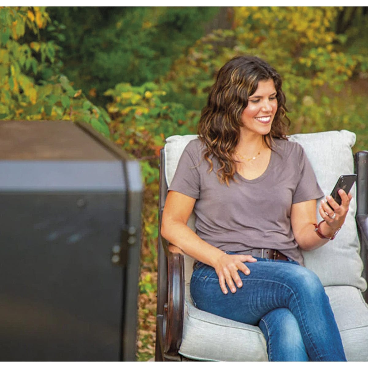 4-Series Vertical Wood Pellet Smoker woman sitting by smoker