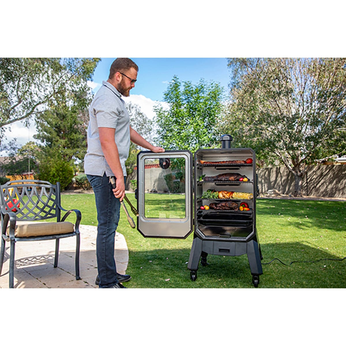 4-Series Vertical Wood Pellet Smoker man smoking meat in backyard