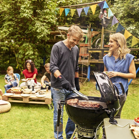 family grilling in backyard