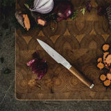 Fiskars Norden Paring Knife on a cutting board with vegetables