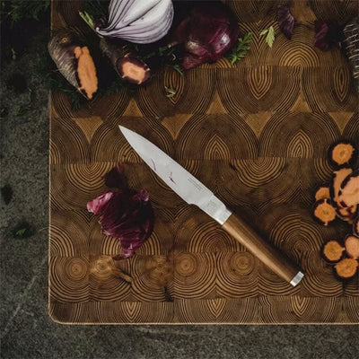 Fiskars Norden Paring Knife on a cutting board with vegetables