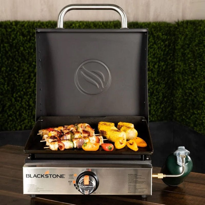 front view of a Blackstone 17" Griddle with Hood  loaded with kebabs and veggies