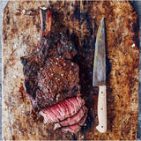 a knife and sliced cutlet on a cutting board from the Gozney Pizza Cookbook Volume 01