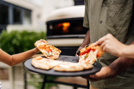 eating pizza prepared in Gozney Dome S1 outdoor oven