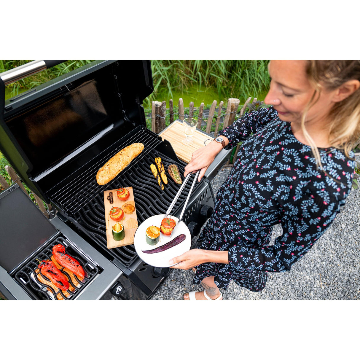 woman grilling food on Napoleon Freestyle 425 SIB