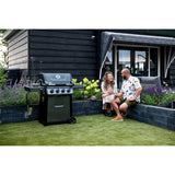 poeple hanging out outdoors next to Napoleon Freestyle 425 4-Burner Gas Grill