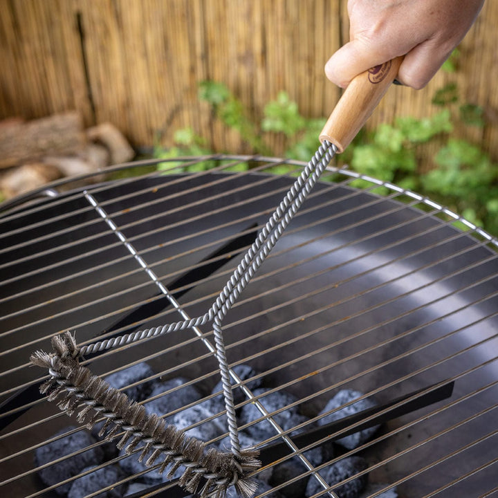 BBQ brush with handle on a grill grate