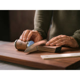 a man using HORL 3 Walnut on a knife