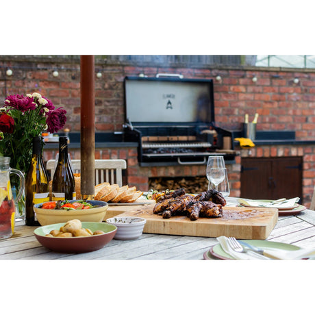 set table with Small Asado Grill Built-in in the background