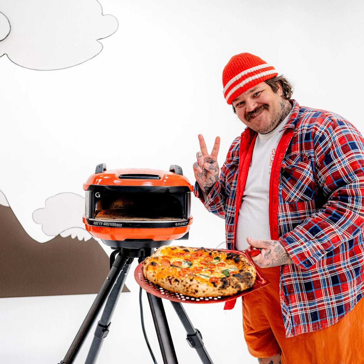 Gozney x Matty Matheson Portable Pizza Oven matty holding pizza and posing