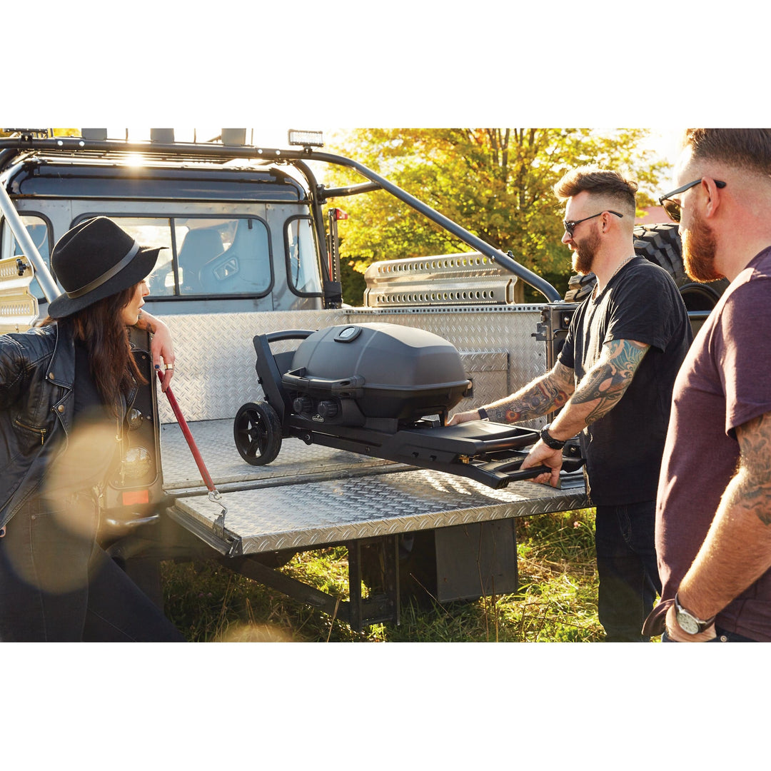 people folding Napoleon Phantom TravelQ portable into a truck