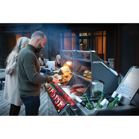 Napoleon Prestige PRO 825 RSBI man and woman grilling at dusk on deck