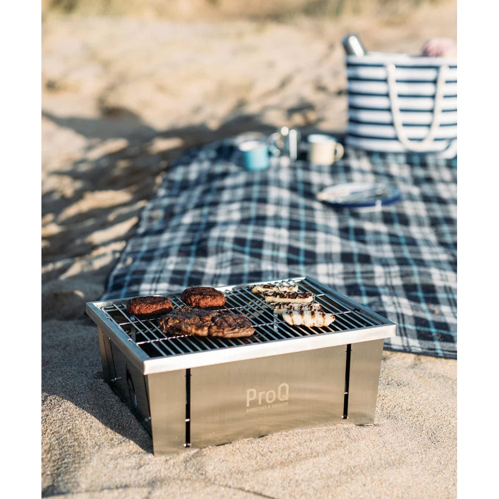 Fold-Flat Portable Charcoal BBQ on a beach