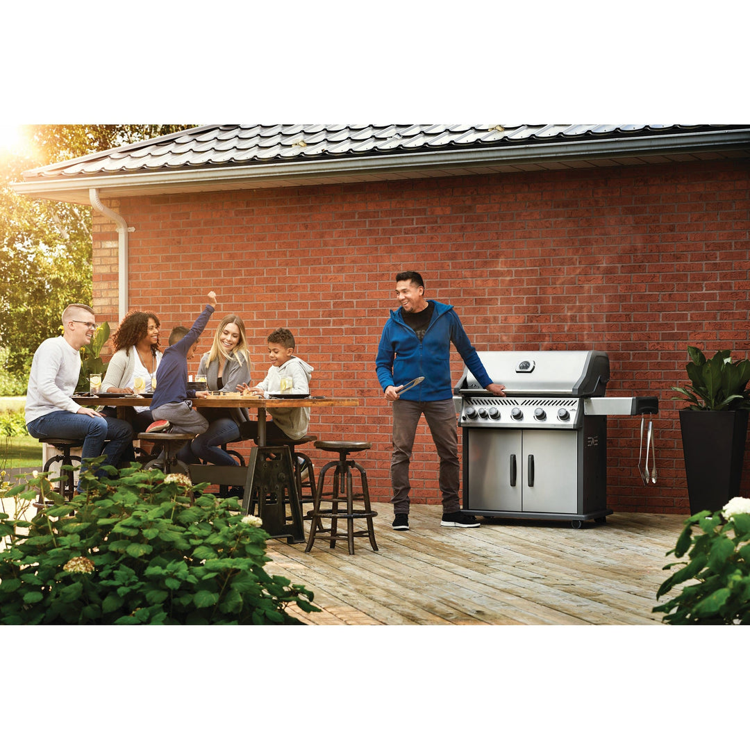 prople grilling on Napoleon Rogue XT 625 SIB on red brick deck 