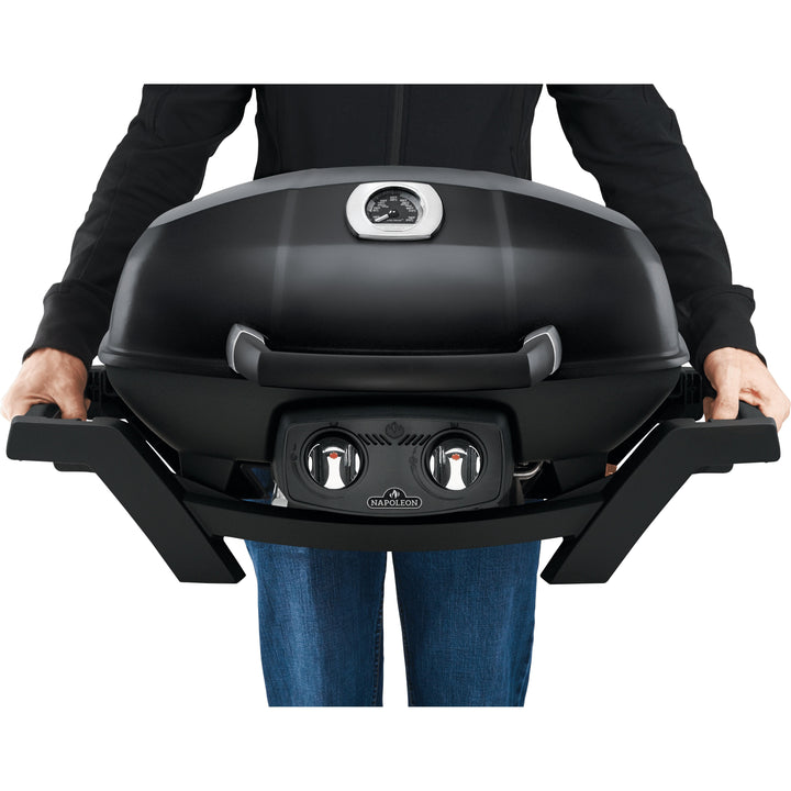 holding Napoleon TravelQ Pro 285 Portable Gas Grill