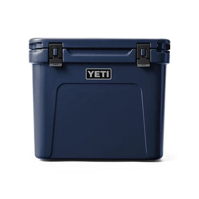  front side of a closed Navy YETI Roadie - 60 Wheeled Cool Box  shown with retracted handle