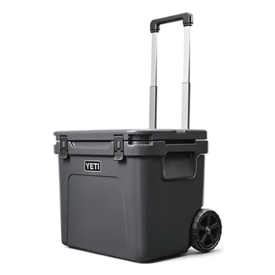 a closed lid Charcoal  YETI Roadie - 60 Wheeled Cool Box shown with periscopic handle